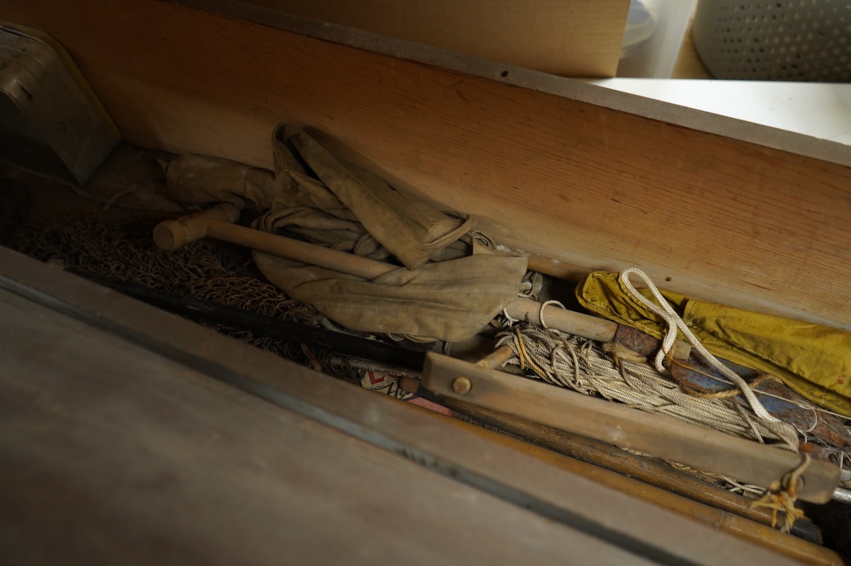 A collection of split cane fishing rods, reels, landing net etc contained in a large wooden box